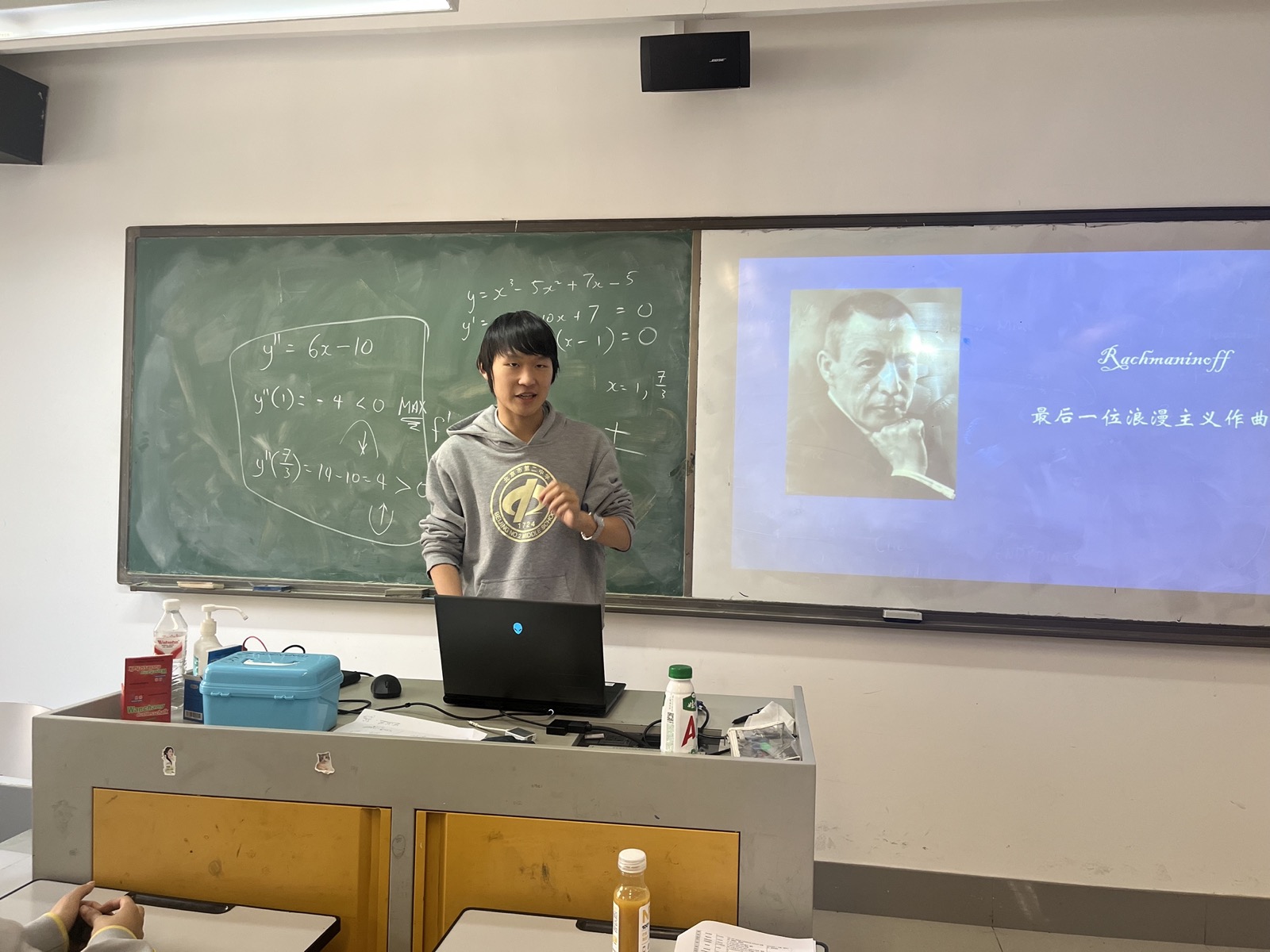James standing beside a projected slide about Rachmaninoff.