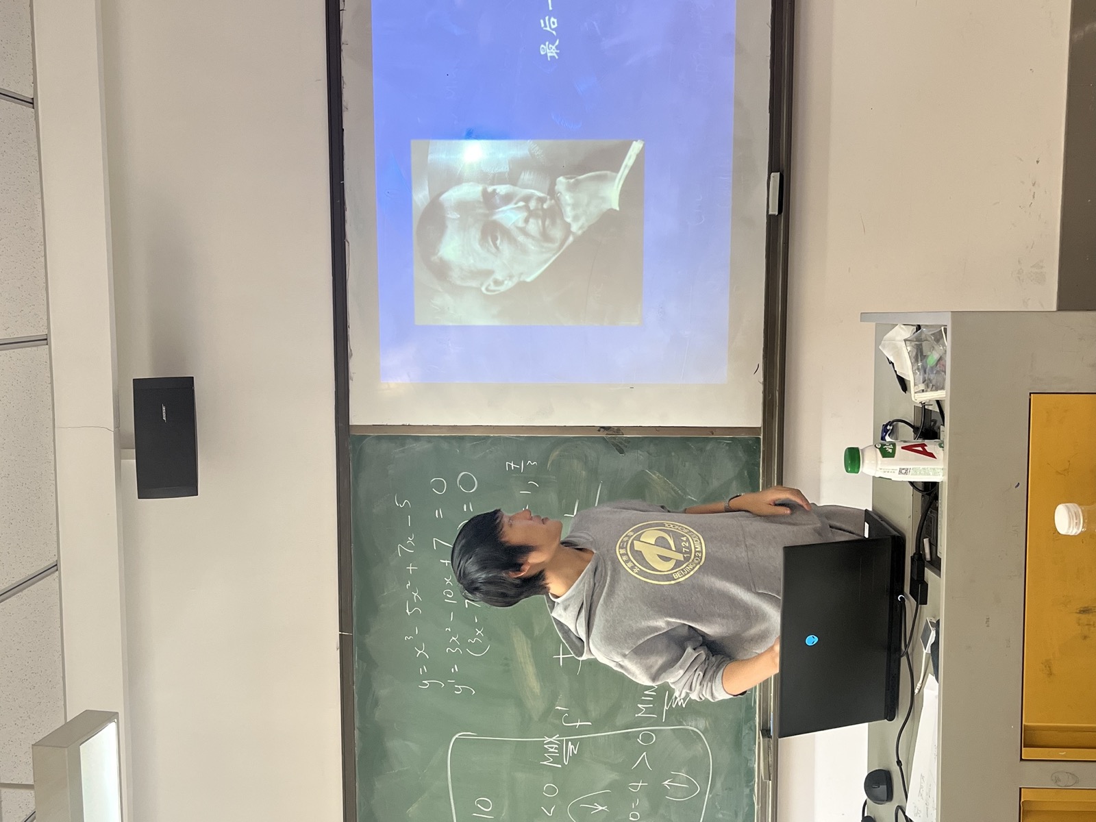 James explaining a classical music slide at the front of the classroom.
