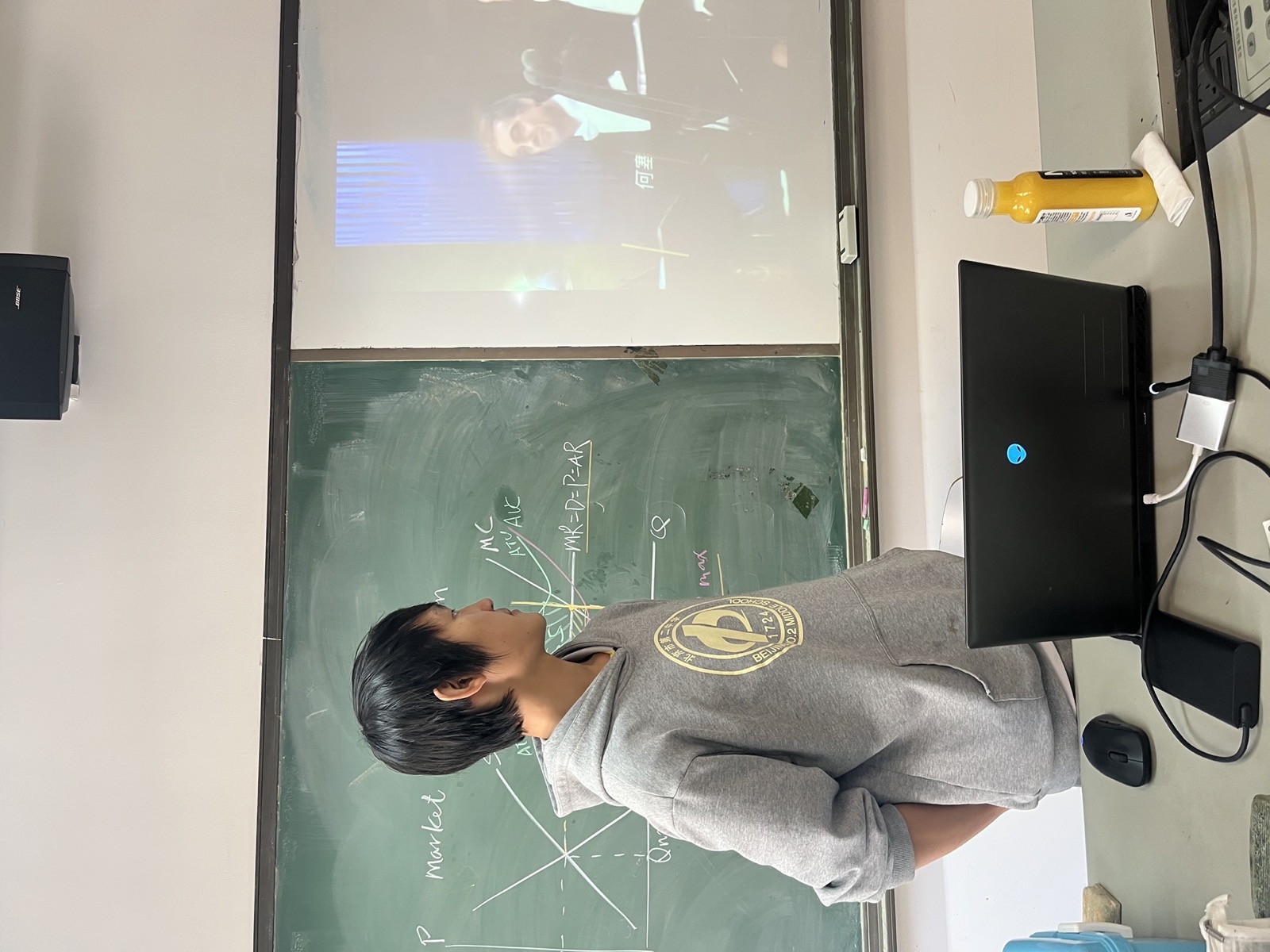 James watching a projected orchestra clip during a lesson.